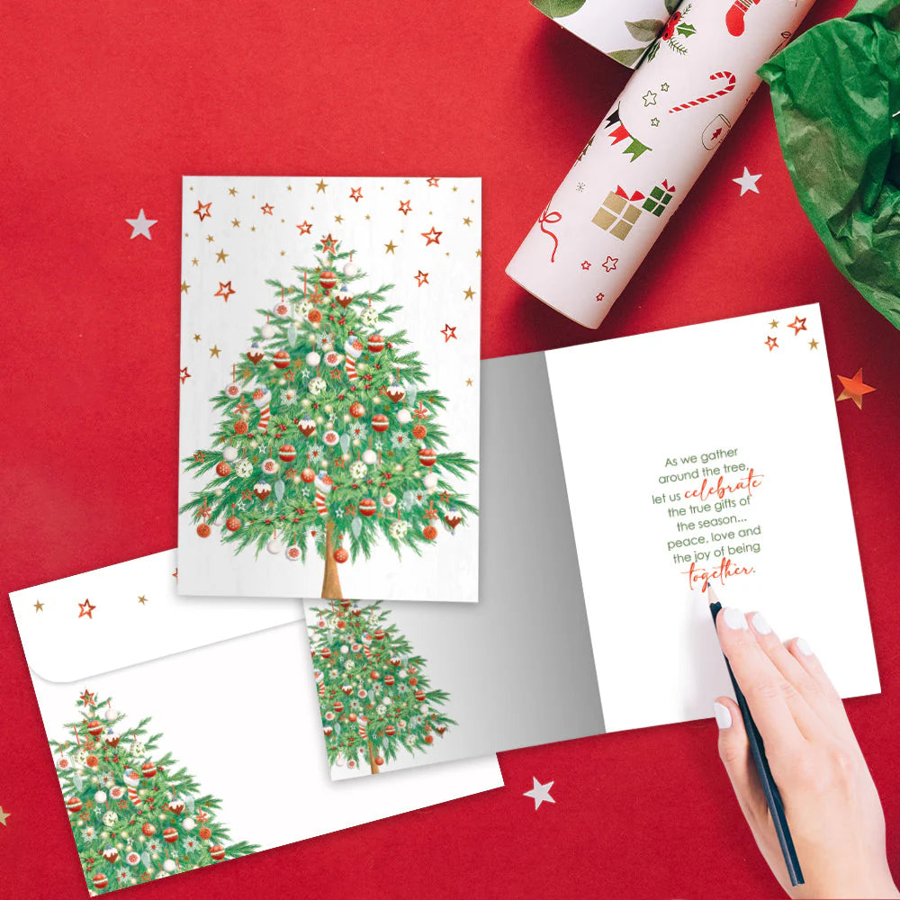 Christmas-themed cards with a decorated tree on a red surface