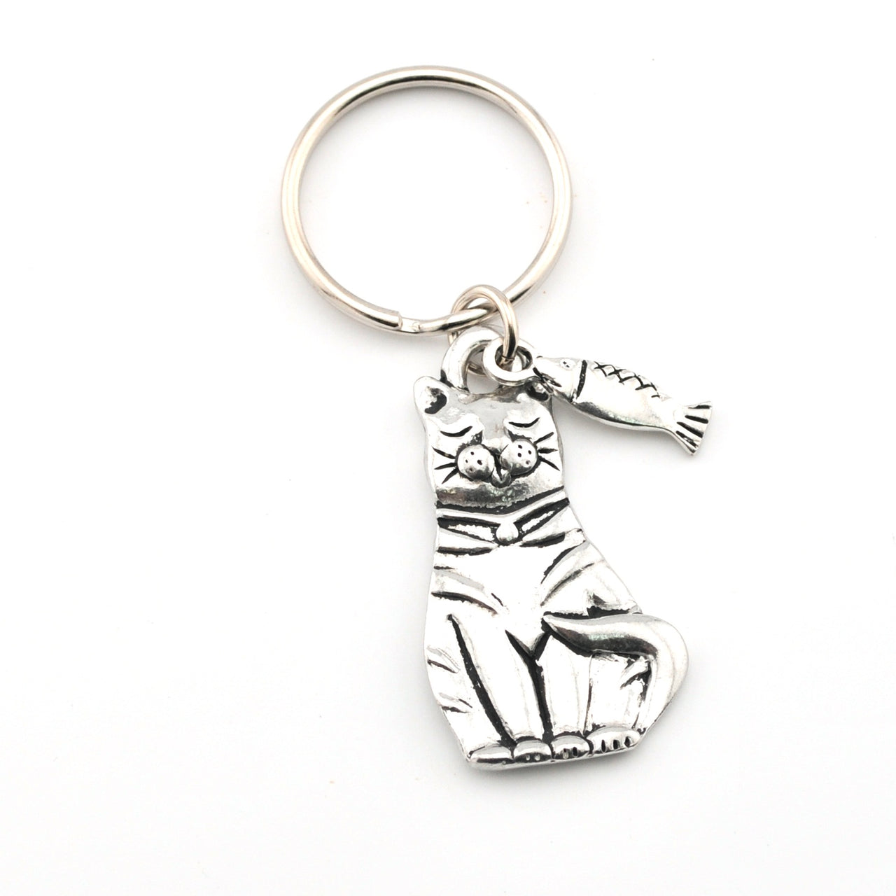Silver cat-shaped keychain with a tag on a white background