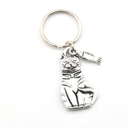 Silver cat-shaped keychain with a tag on a white background