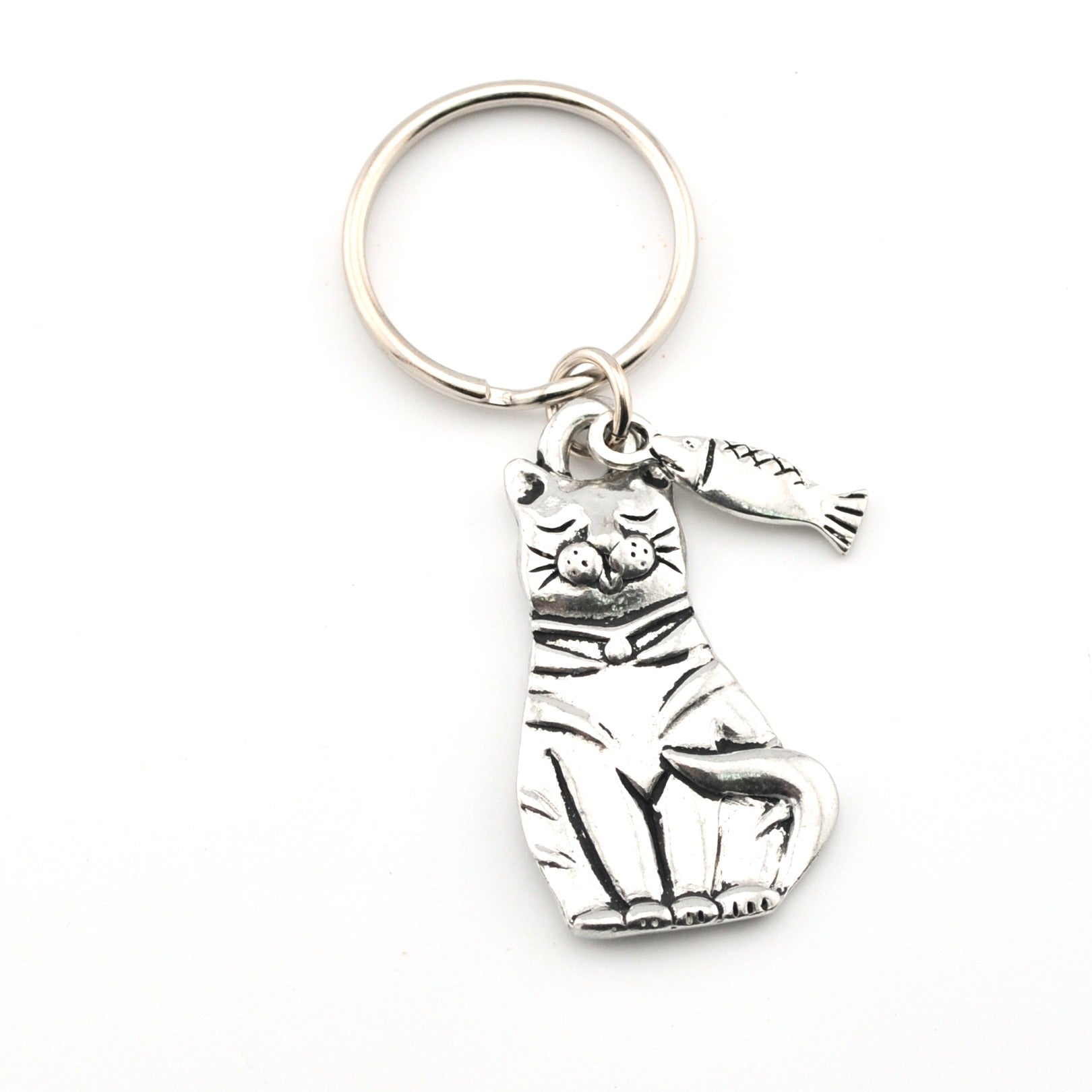 Silver cat-shaped keychain with a tag on a white background