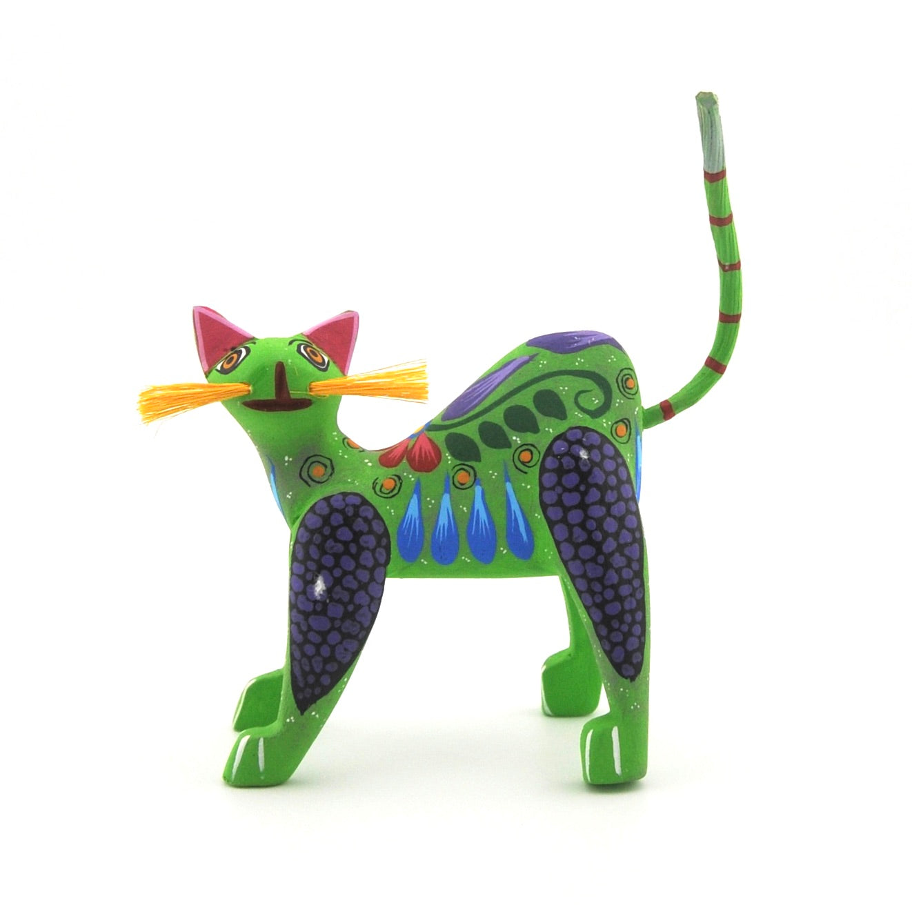 Colorful cat figurine with a long tail on a white background