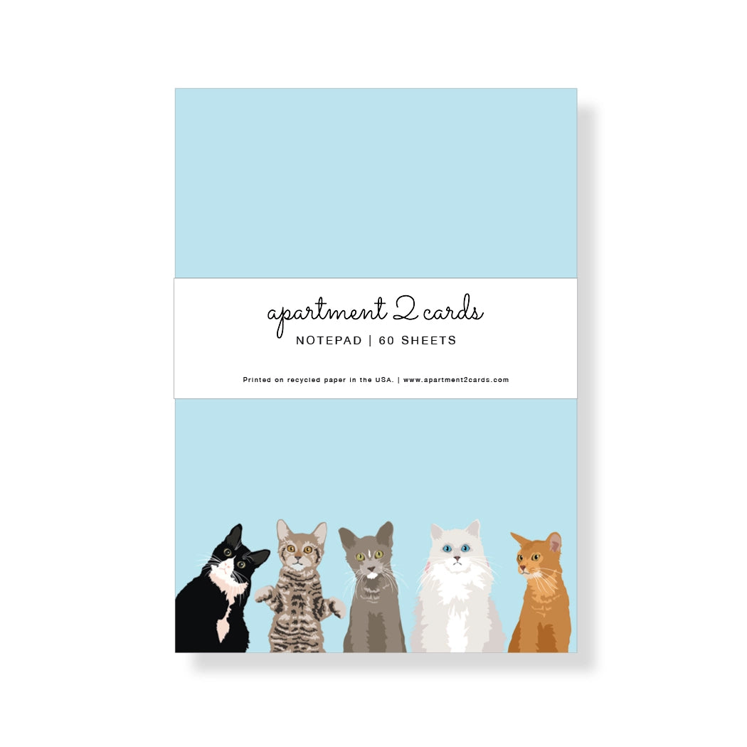 Notepad with illustrations of cats on a light blue background, featuring the brand 'apartment 2 cards'.