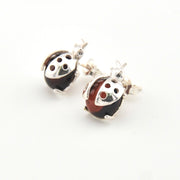 Pair of ladybug-shaped earrings on a white background