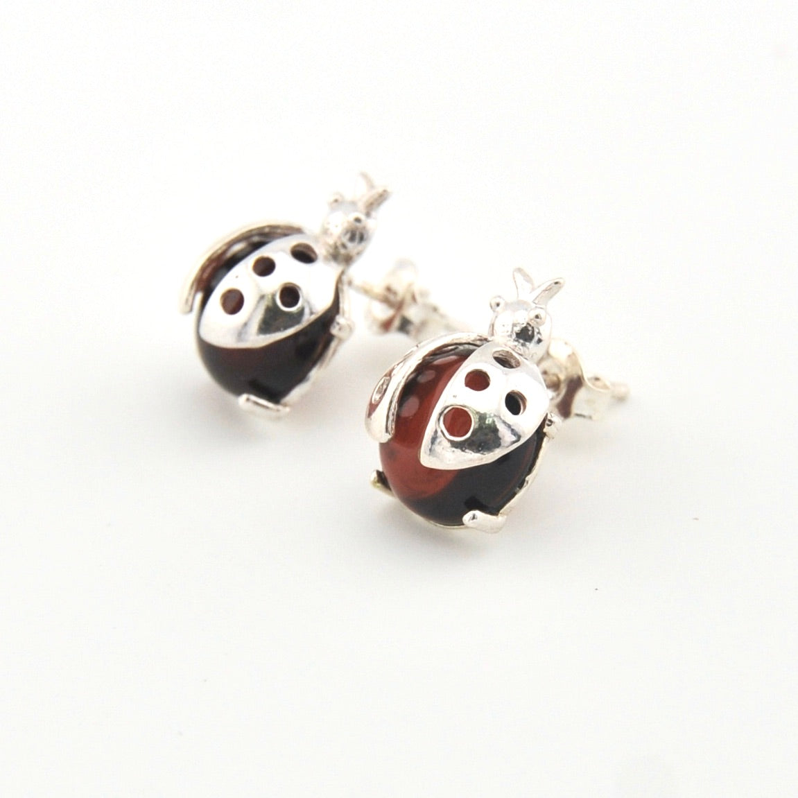 Pair of ladybug-shaped earrings on a white background