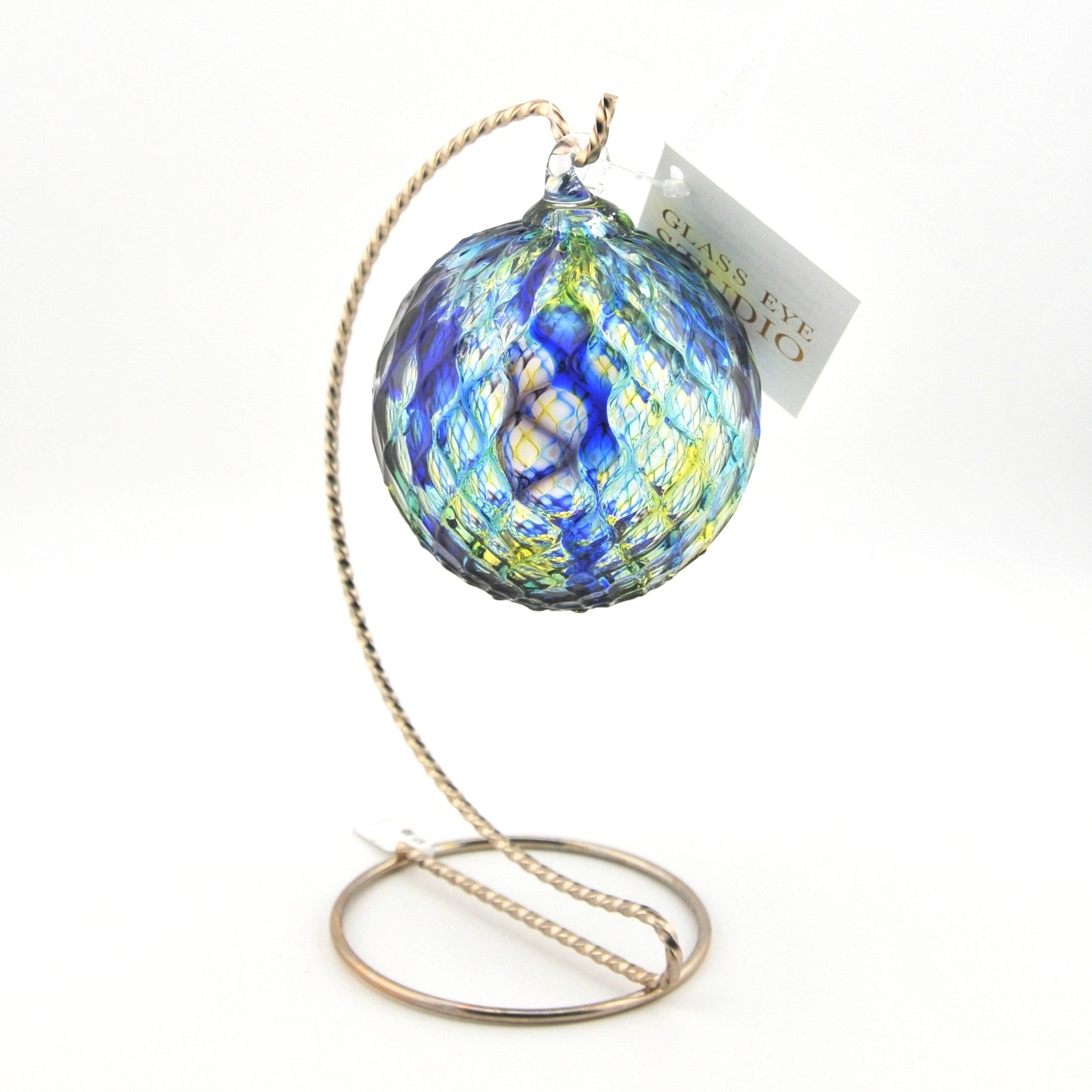 Decorative glass ornament with blue and yellow pattern on a white background