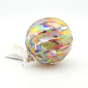 Multicolored glass ornament on a white background