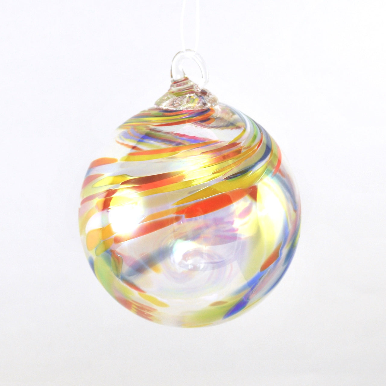 Colorful glass ornament with swirl pattern on a white background