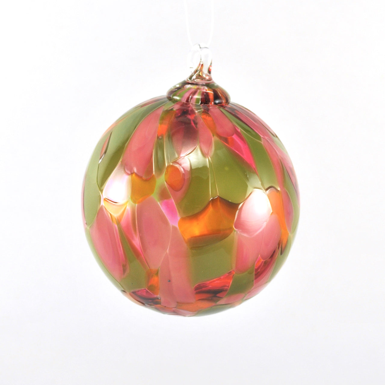 Decorative glass ornament with pink and green patterns on a white background