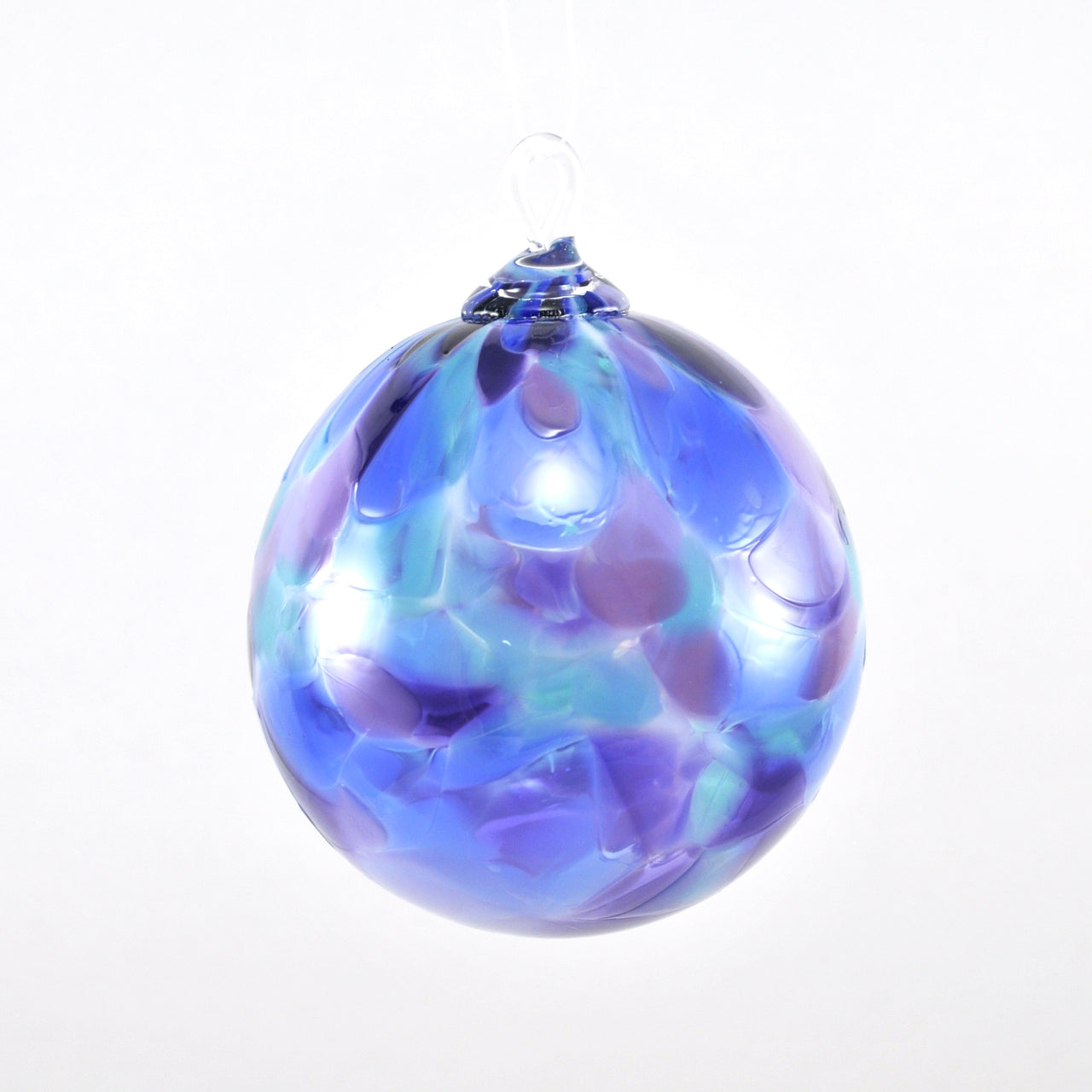 Glass ornament with blue and purple hues on a white background