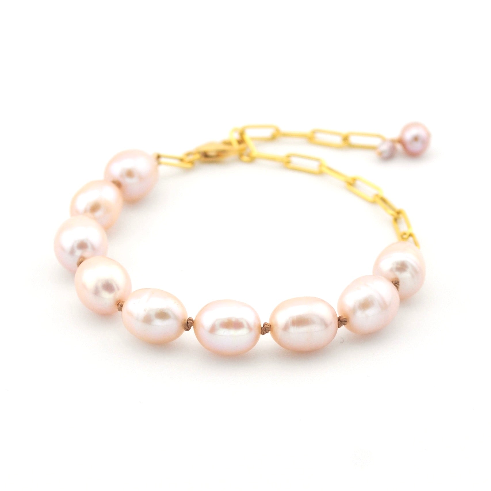 Pearl bracelet with gold chain on a white background