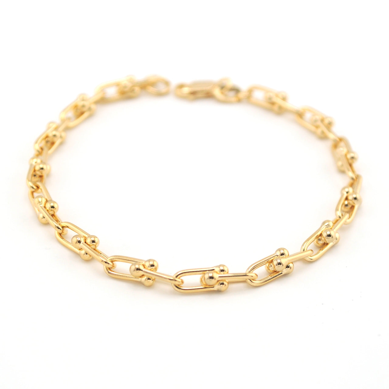 Gold chain bracelet on a white background