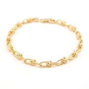 Gold chain bracelet on a white background