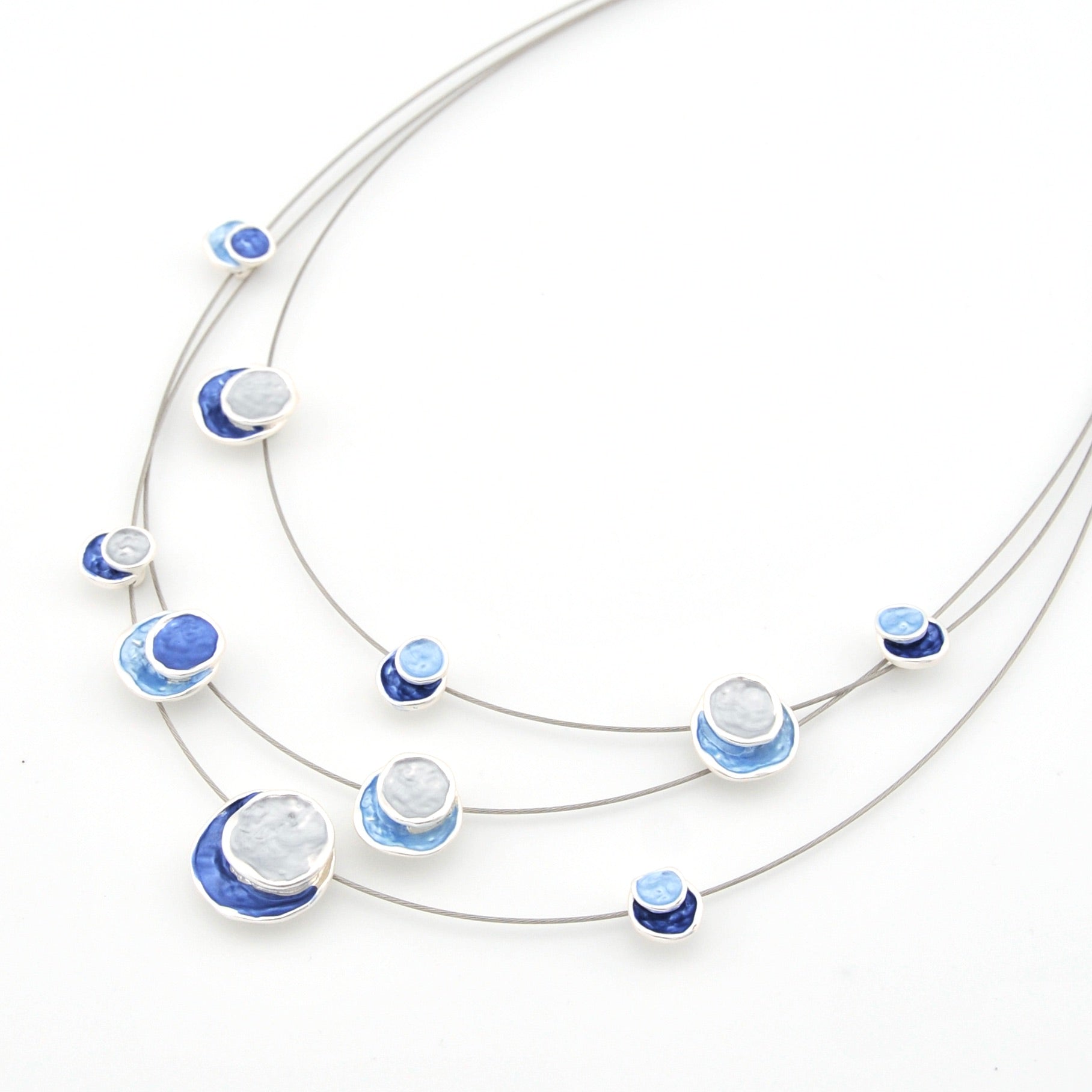 Necklace with blue and white circular pendants on a white background