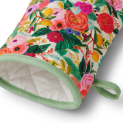 Floral patterned oven mitt with green trim on a white background