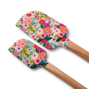Two floral-patterned spatulas with wooden handles on a white background
