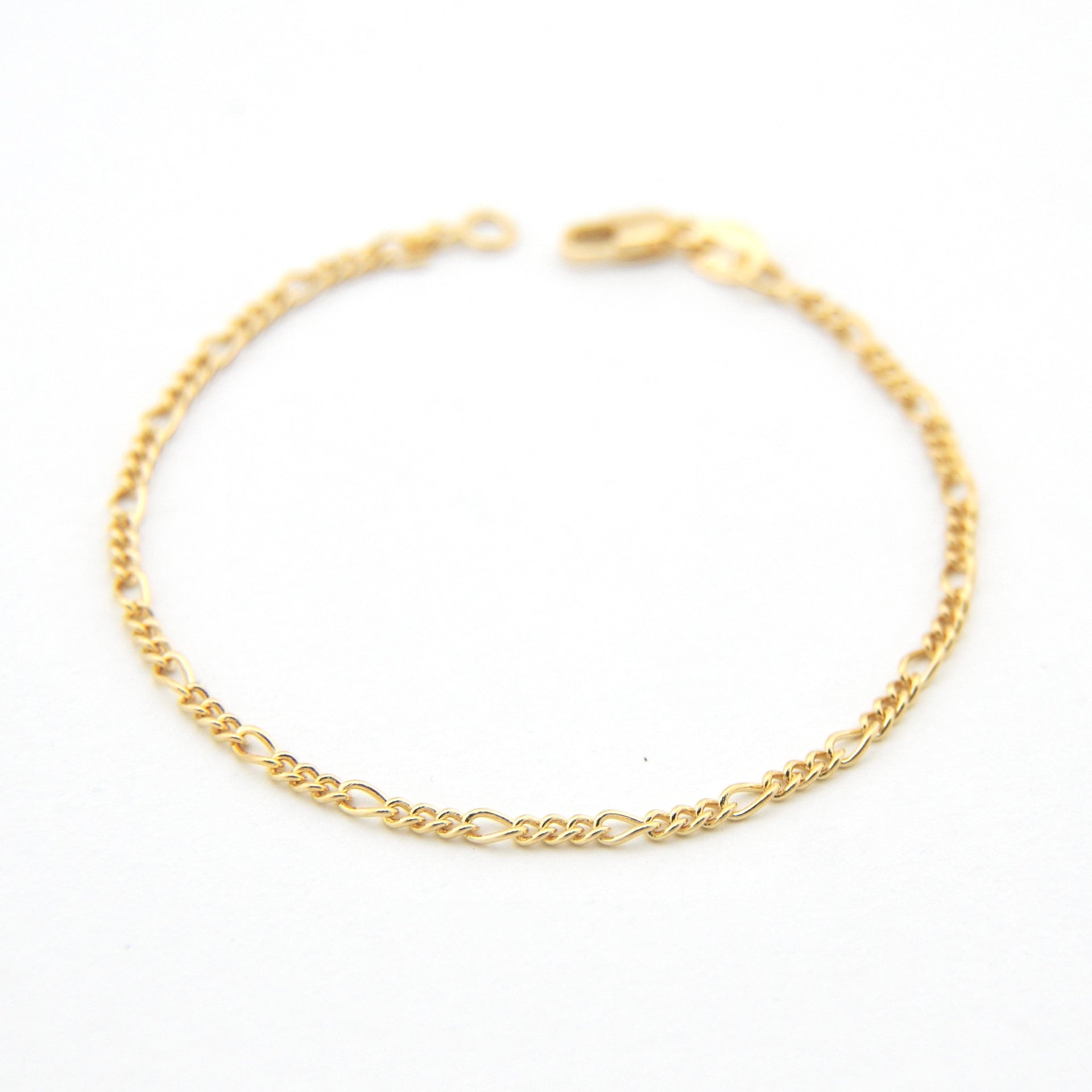 Gold chain bracelet on a white background