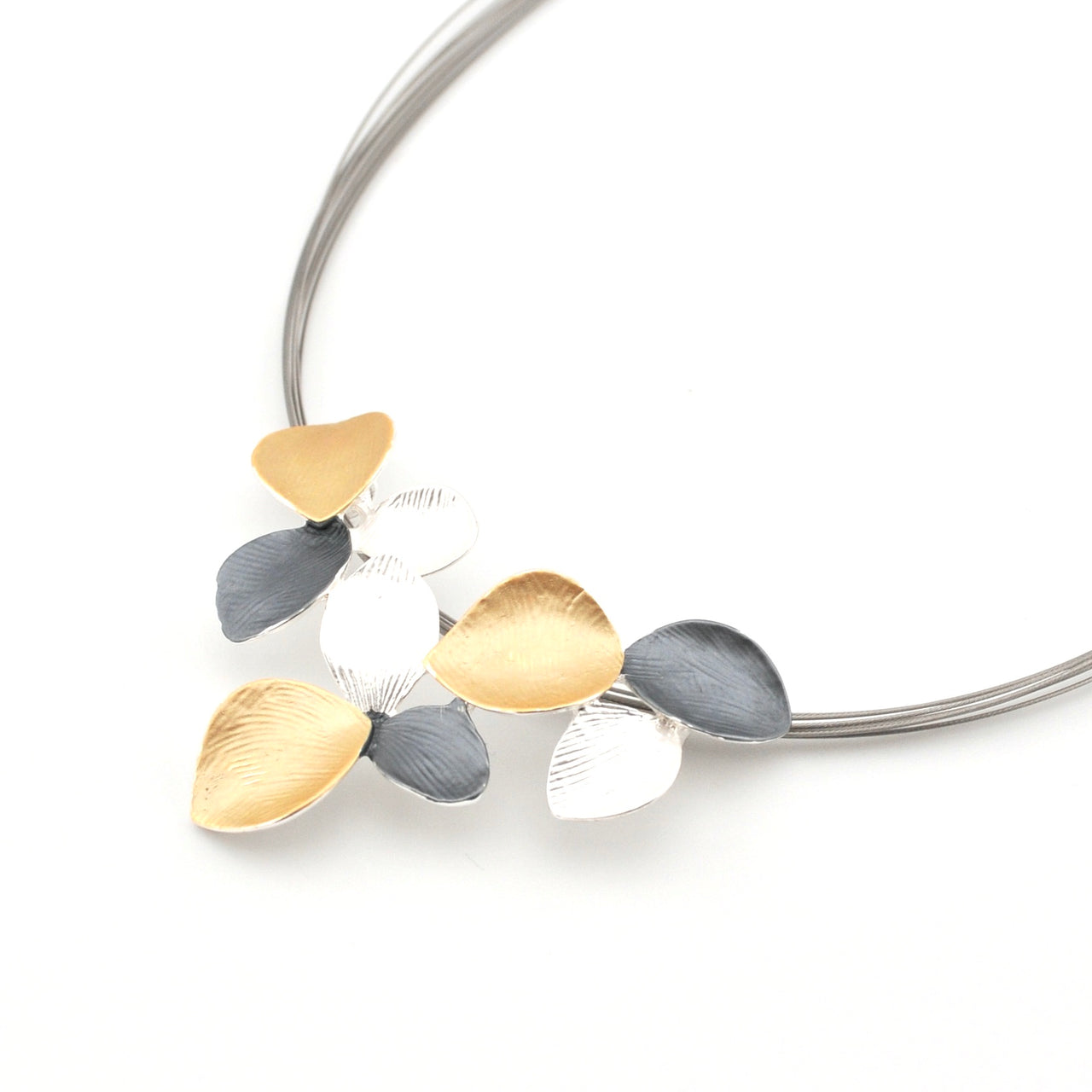 Necklace with leaf-shaped pendants in gold, silver, and gray on a white background