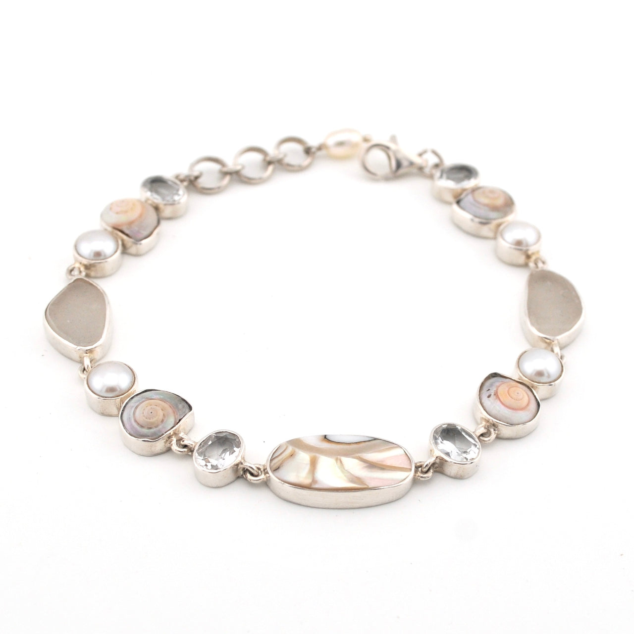Silver bracelet with various sea shells and pearl on a white background