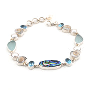 Silver bracelet with multicolored stones on a white background