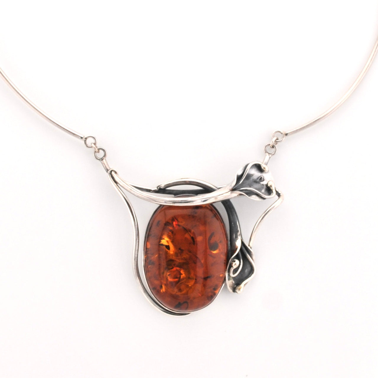 Silver necklace with a amber pendant on a white background