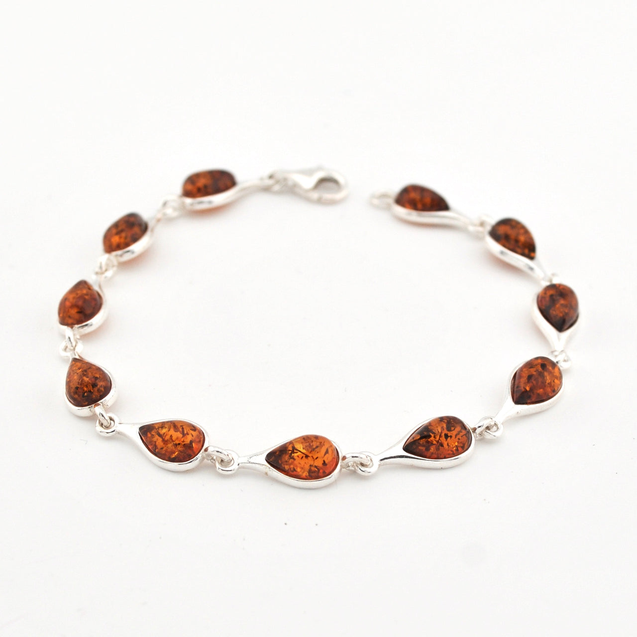 Silver bracelet with amber on a white background