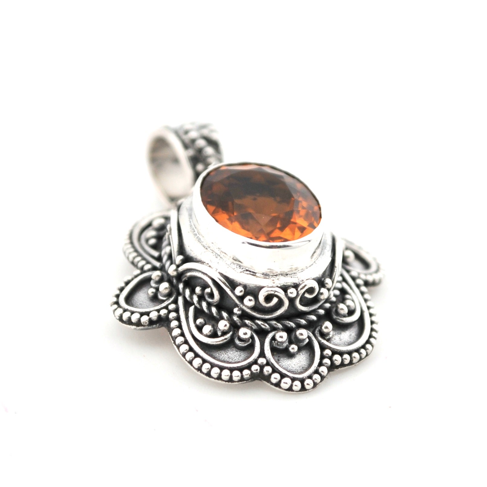 Silver pendant with a brown gemstone on a white background