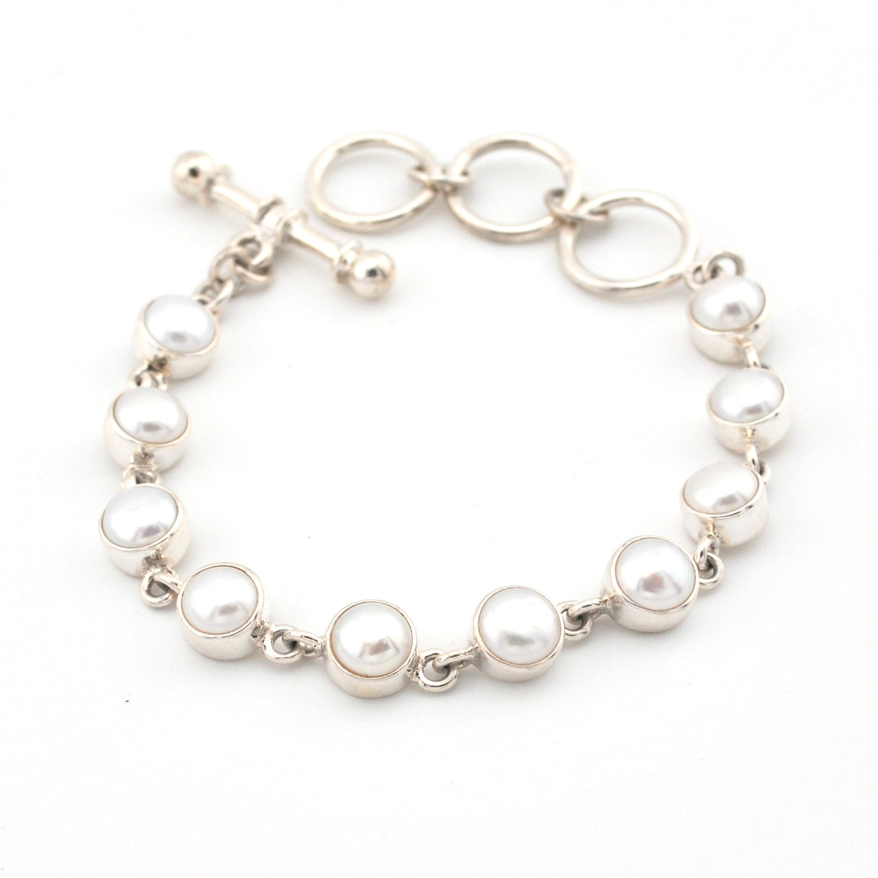 Pearl bracelet with silver chain on a white background