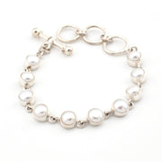 Pearl bracelet with silver chain on a white background