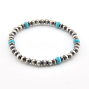 Silver beaded bracelet with blue accents on a white background