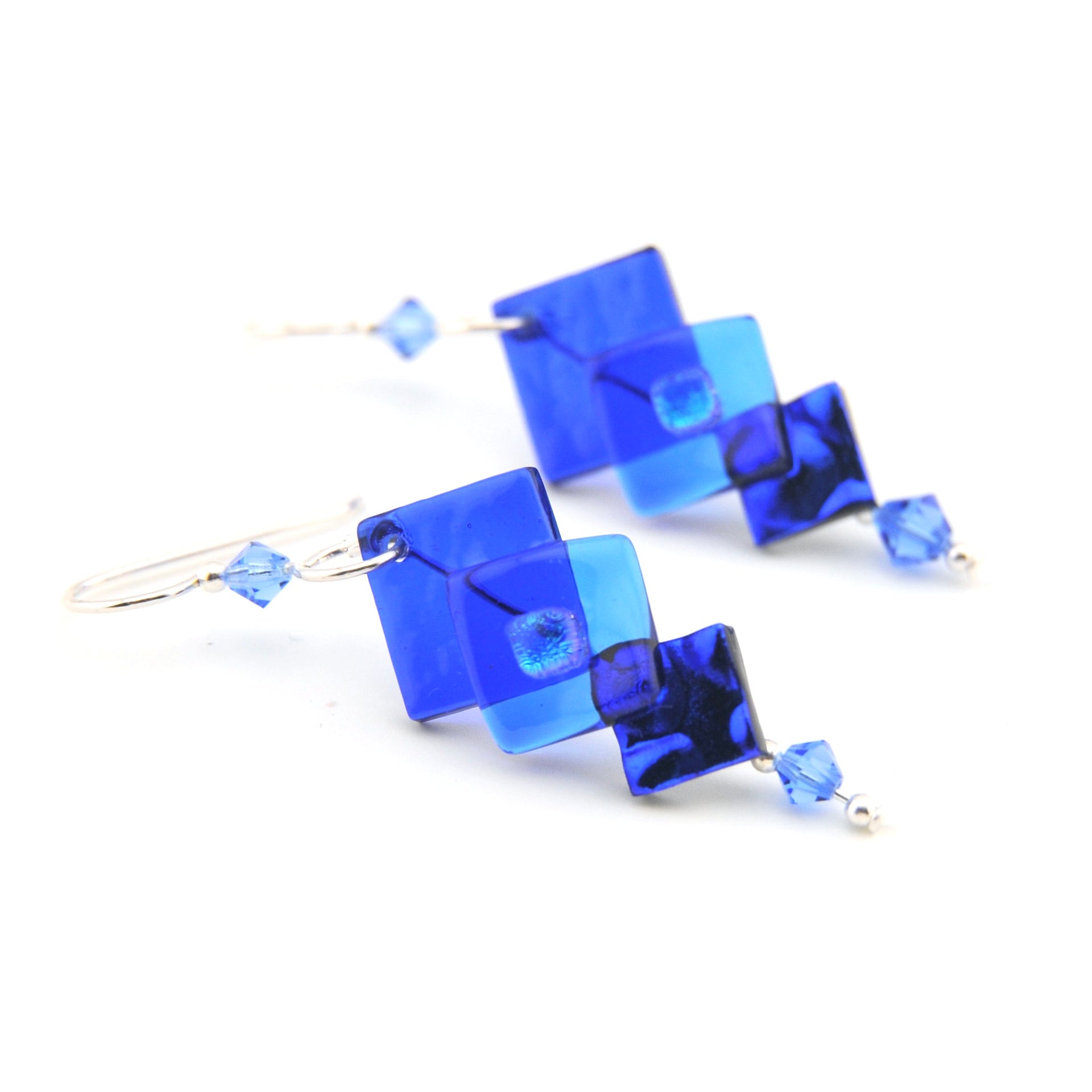 Blue square-shaped earrings on a white background