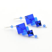 Blue square-shaped earrings on a white background