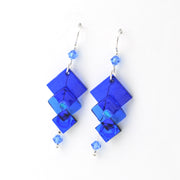 Blue square-shaped earrings with small beads on a white background