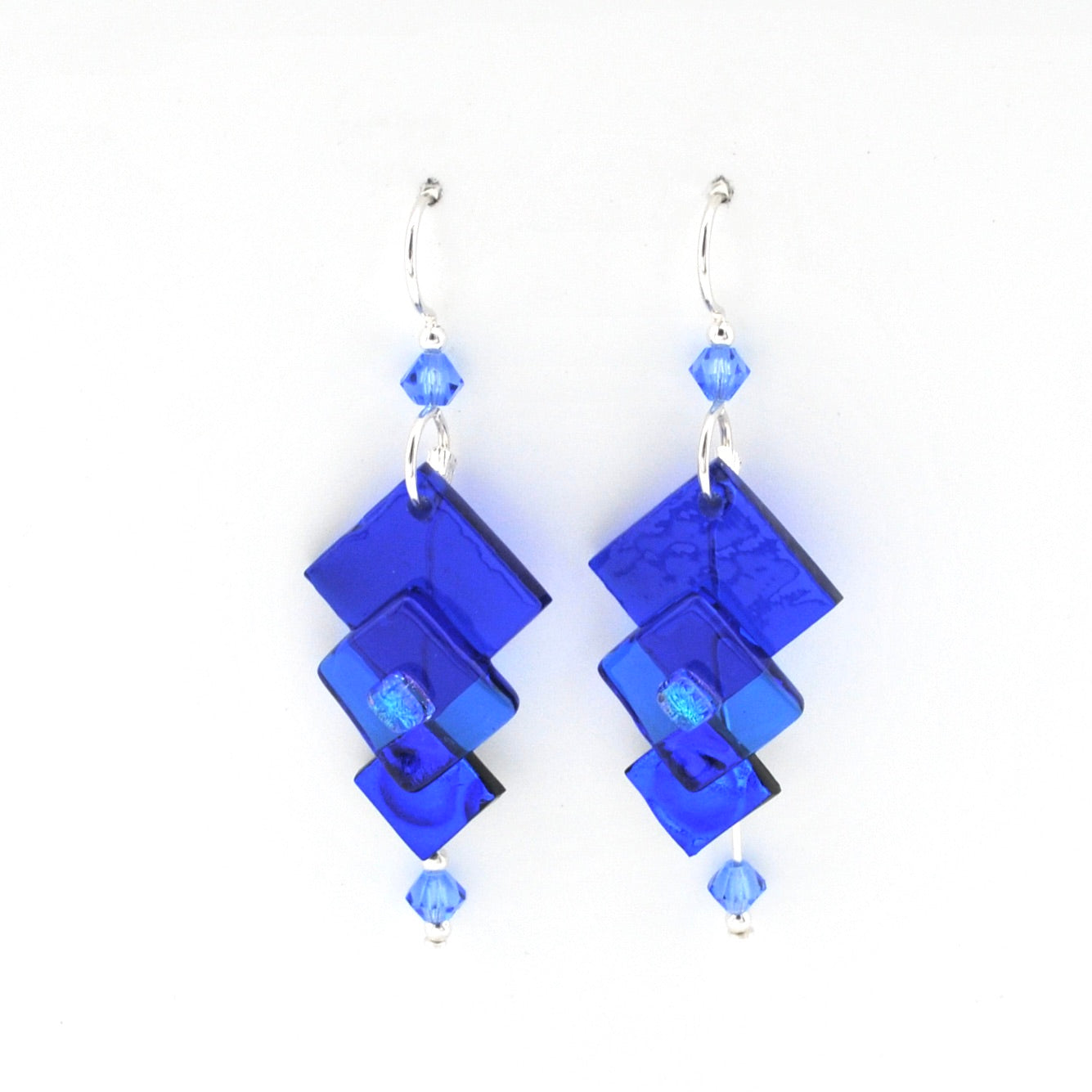 Blue geometric earrings on a white background