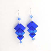 Blue geometric earrings on a white background