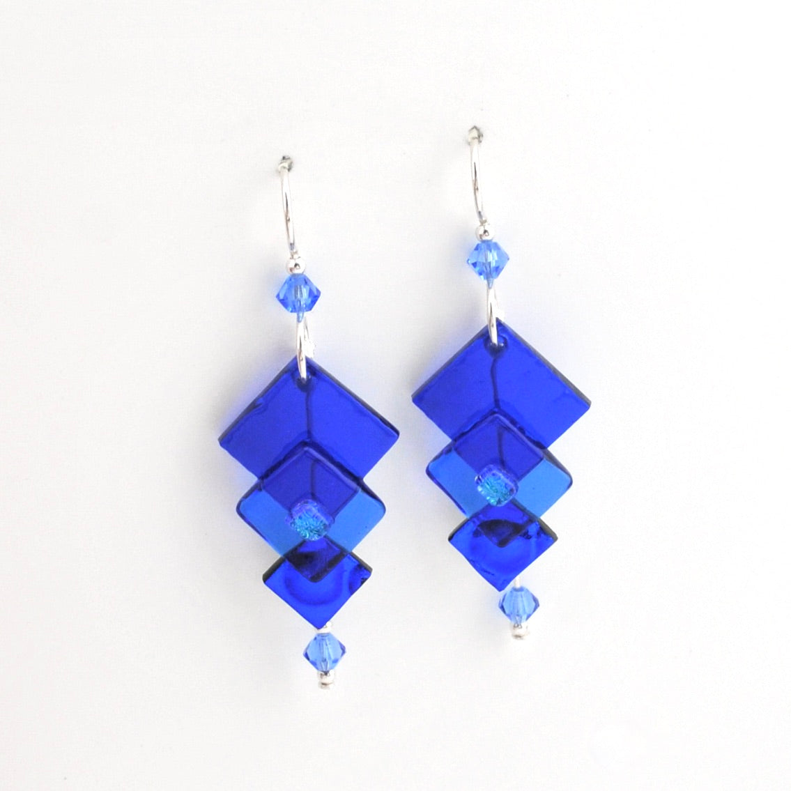 Blue geometric earrings on a white background