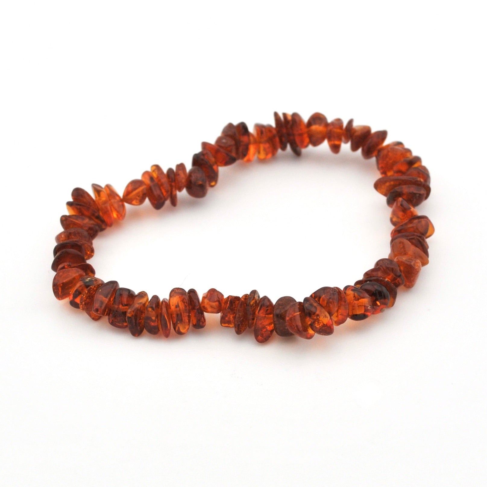 A handmade beaded necklace made of small, irregular, faceted amber chips in warm orange-brown tones, displayed on a clean white background.