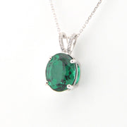 Green gemstone pendant on a white background