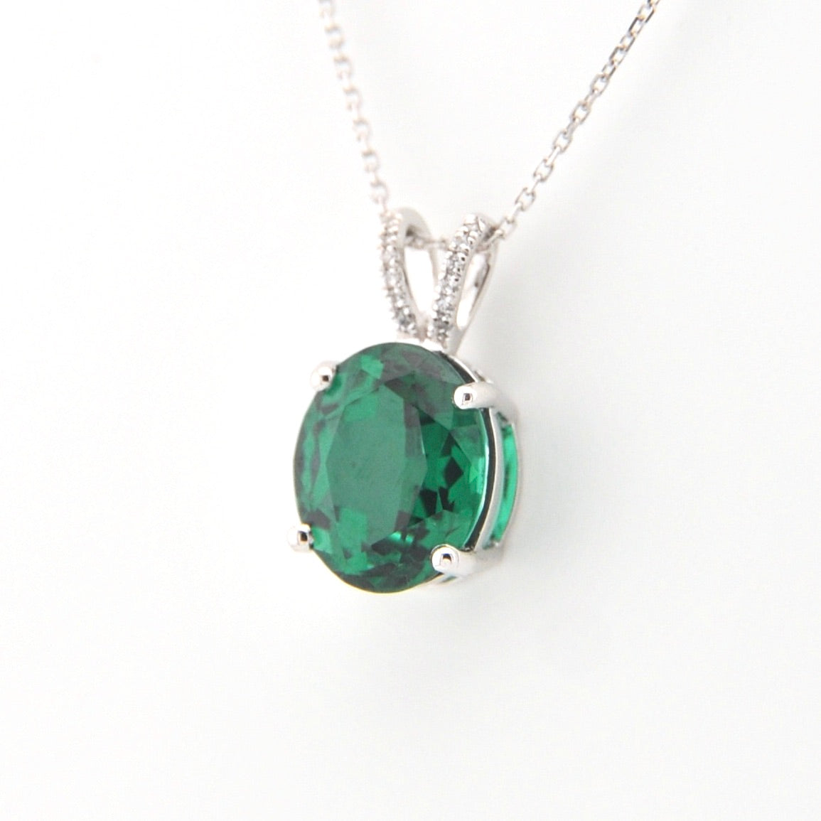 Green gemstone pendant on a white background