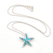 Starfish-shaped pendant with blue opal inlay on a silver chain against a white background