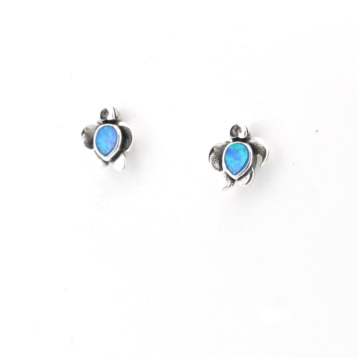 Pair of turtle-shaped earrings with blue gemstones on a white background