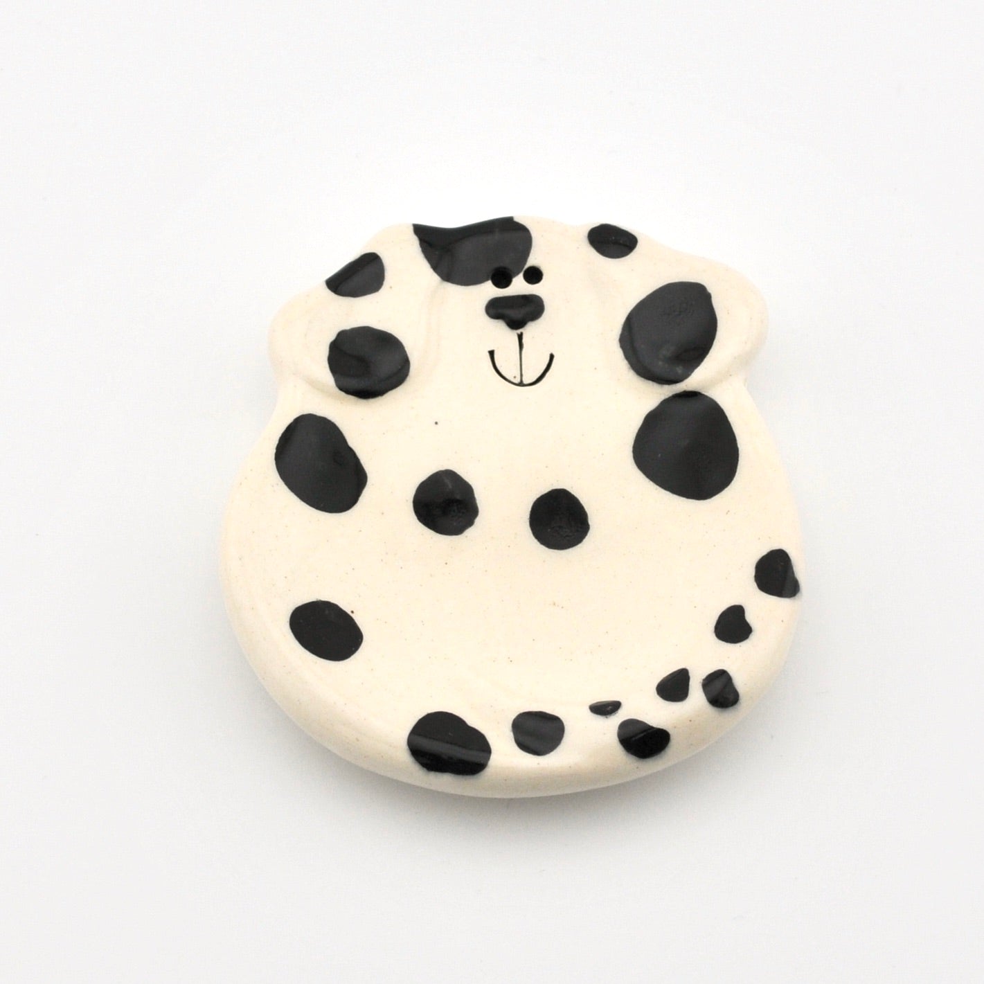 Round ceramic dish with a dalmatian dog design on a white background