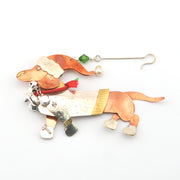 Decorative dog ornament with a hat and scarf on a white background
