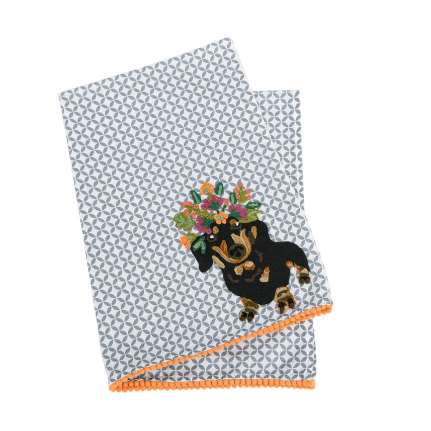 Towel with a dog design and floral crown on a white background