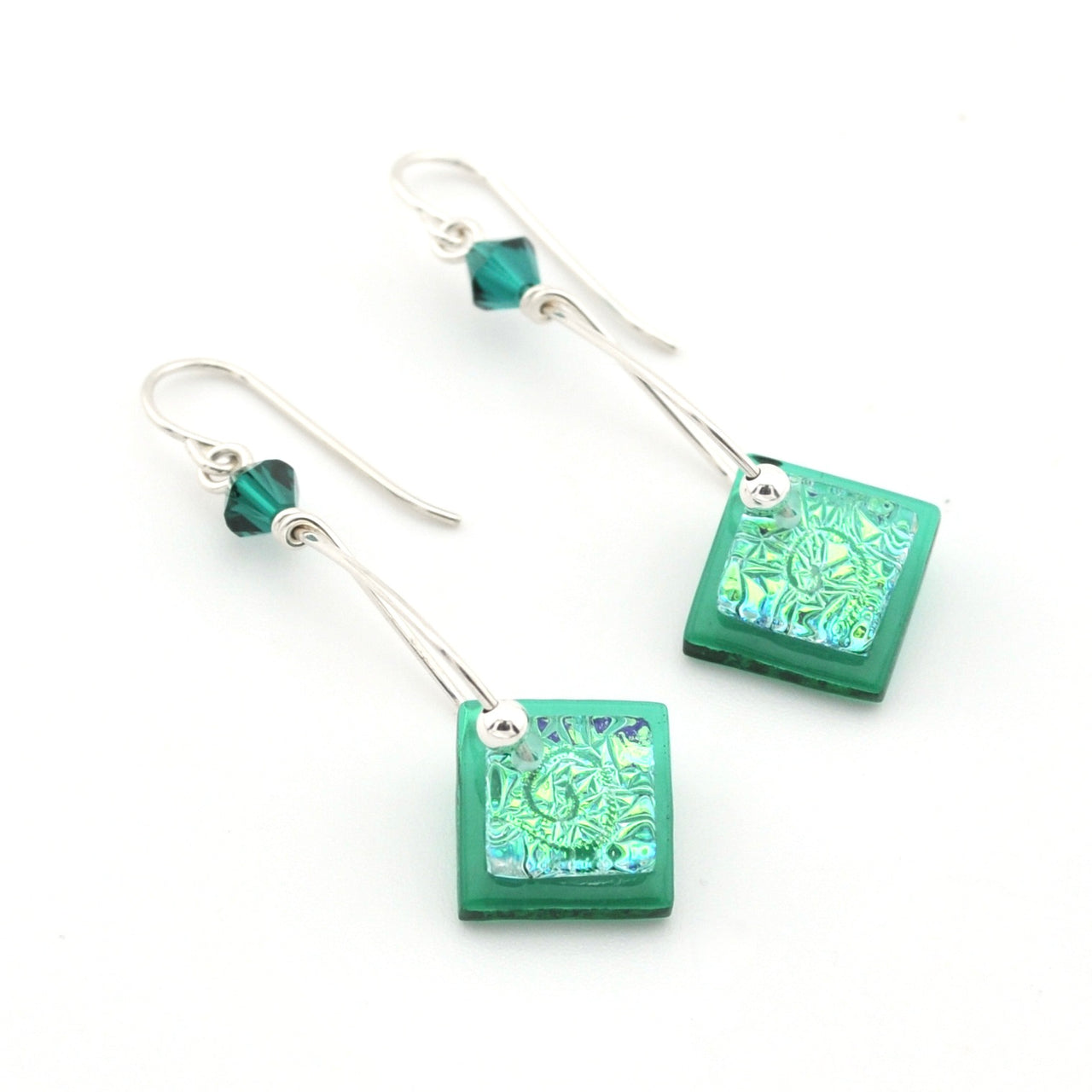 Green square earrings with intricate patterns on a white background