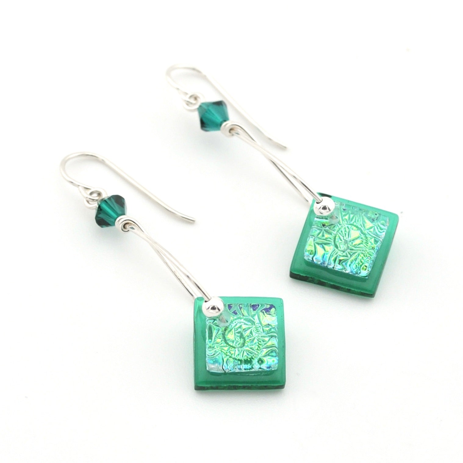 Green square earrings with intricate patterns on a white background