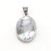 Marble-patterned pendant with silver frame on a white background