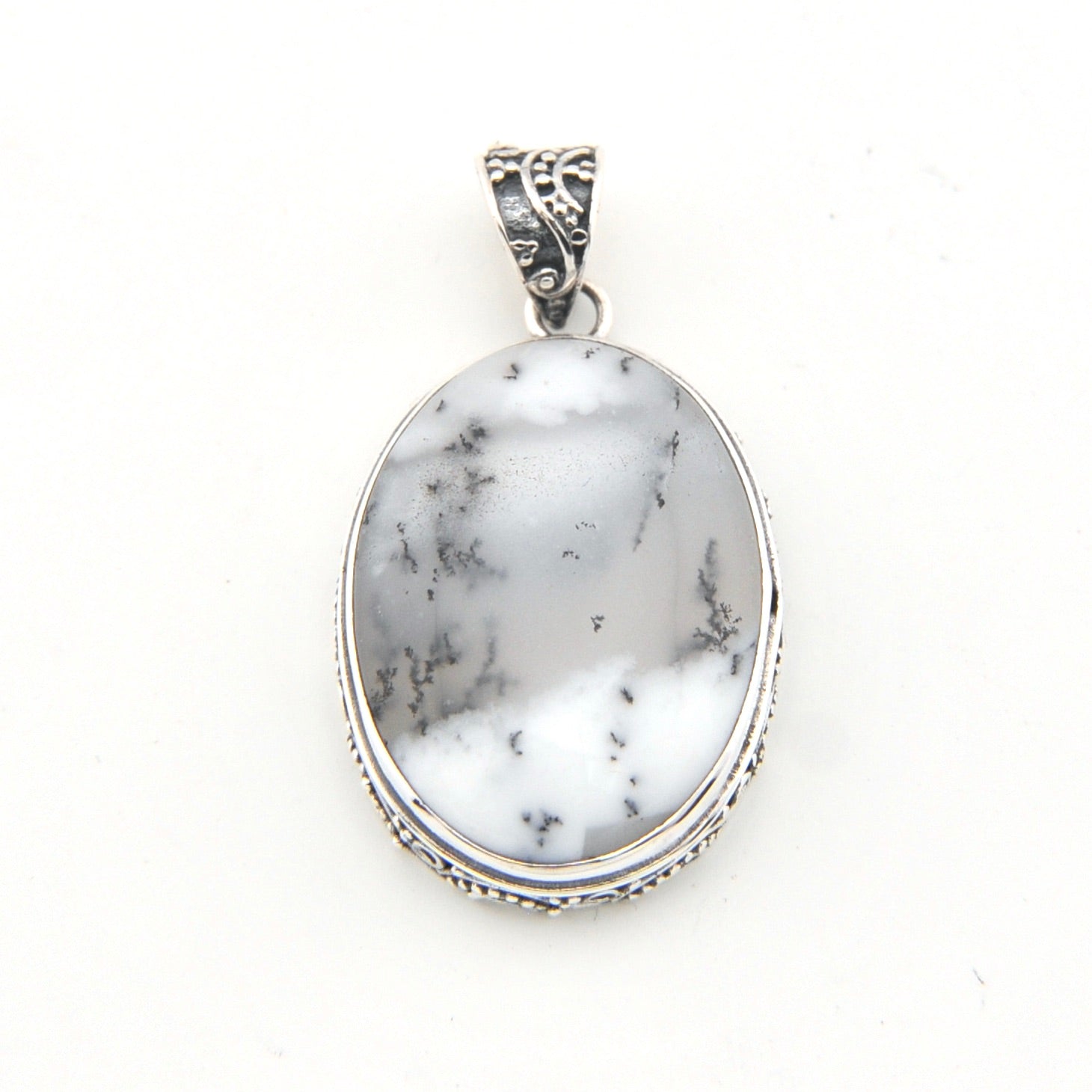 Marble-patterned pendant with silver frame on a white background