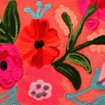 Colorful floral embroidery on a pink background