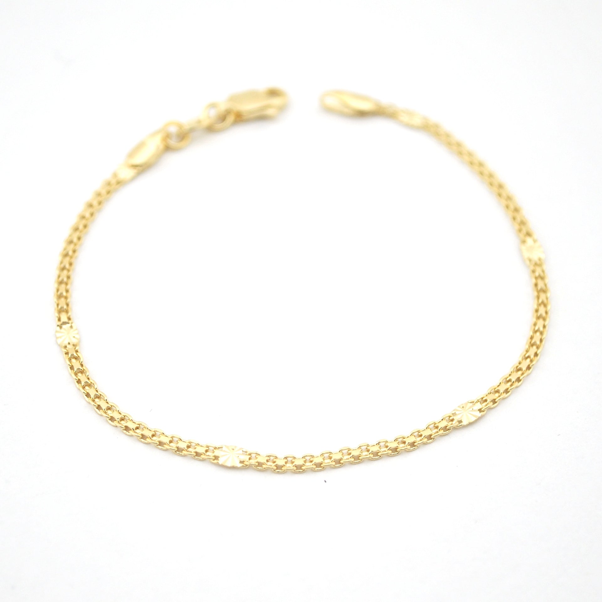 Gold chain bracelet on a white background