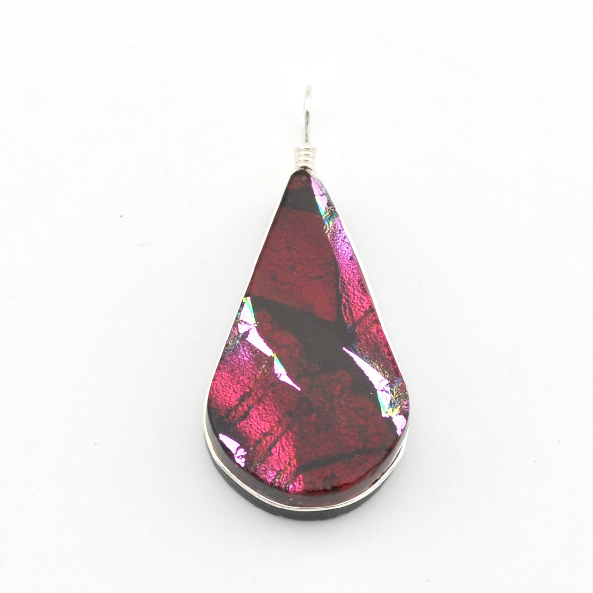 A teardrop-shaped glass pendant featuring a marbled pattern of deep red, magenta, and black, suspended from a silver wire on a plain white background.